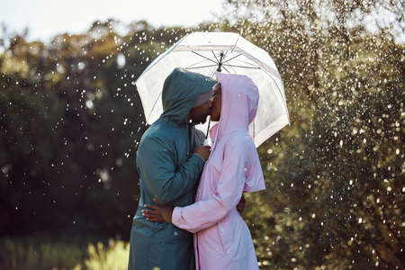 Theres nothing more romantic than sharing a passionate kiss in the rain. an affectionate couple...