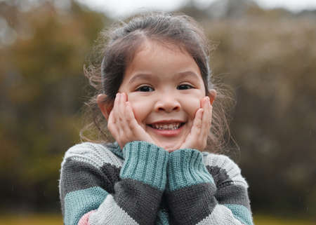 Can I go play now. an adorable little girl standing alone in the park and feeling excited.の写真素材