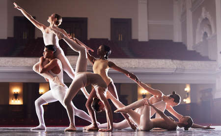 This is the performance of your life. a group of diverse ballet dancers performing in a theater.