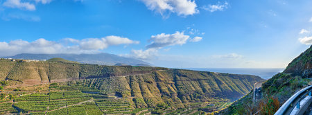 Beautiful landscape of a small agricultural village on a sunny afternoon near a highway or busy road for logistics or transport of goods. Banana plantations in the town of Los Llanos, La Palma, Spainの写真素材