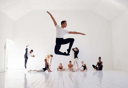 Dance is your pulse, your heartbeat. a group of ballet dancers practicing a routine in a dance...
