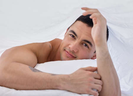 The right bed makes all the difference. a handsome young man lying in bed.