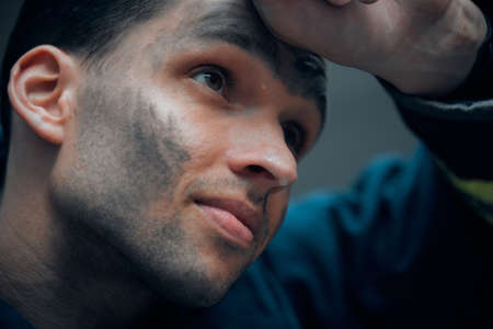 Finding purpose in fighting fires. Closeup shot of a handsome young male firefighter looking thoughtful while standing outside.の写真素材