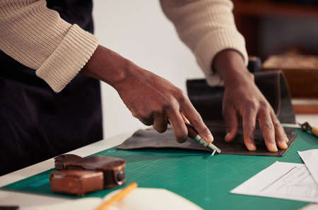 For all your leather needs. an unrecognizable male designer working with leather in his design...