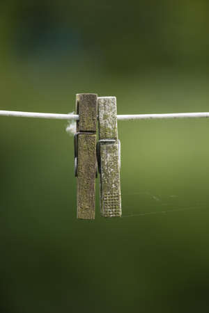 Copy space of old clothespins hanging on abandoned washing or laundry line with bokeh outside....