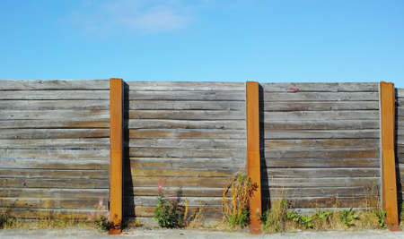 Old wooden fence outside in a garden at home. The vintage architecture of an enclosure surrounding a...