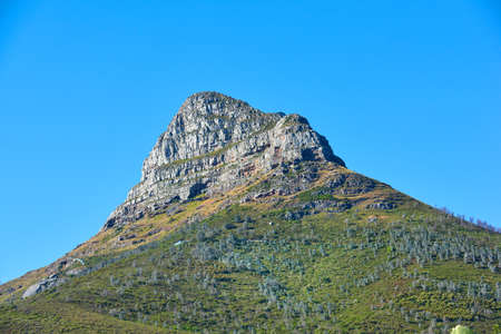 Lions Head mountain with a blue sky and copy space. Beautiful below view of a rocky mountain peak...