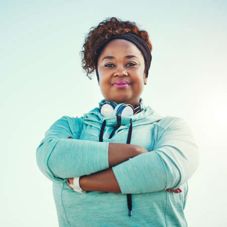 Portrait of a sporty young woman standing outdoors.の写真素材
