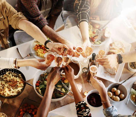Friendship is a good reason to celebrate. a group of young friends making a toast at a dinner party.