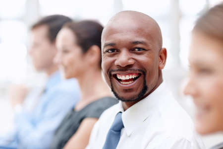 I will achieve - Business motivation. Handsome African American businessman gives you a big smile while attending a conference.の写真素材