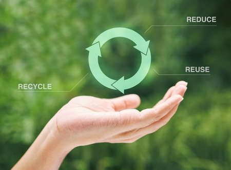 Hand holding a digital recycle symbol. A digital recycling symbol hovering over a hand. Using...