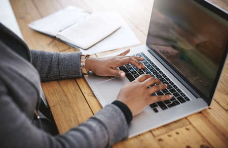 Time to get those deadlines met. Closeup shot of an unrecognizable businessman using a laptop in an...