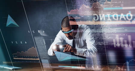 Technology is changing the way we think about business. a handsome young businessman using a digital interface.の写真素材