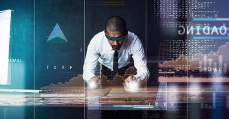 Business done right in his domain. a handsome young businessman using a digital interface.