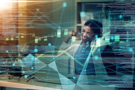 Success happens when you combine passion with ambition. a happy young businesswoman celebrating at her desk in a modern office.の写真素材