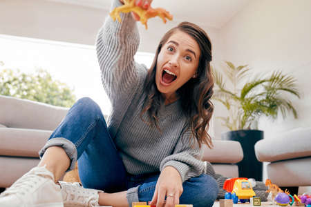 Mothers love is peace. a woman playing with her child at home.の写真素材