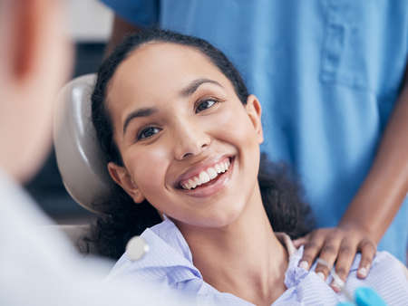 Her smile lights up a room. a young woman visiting her dentist for a checkup.の写真素材