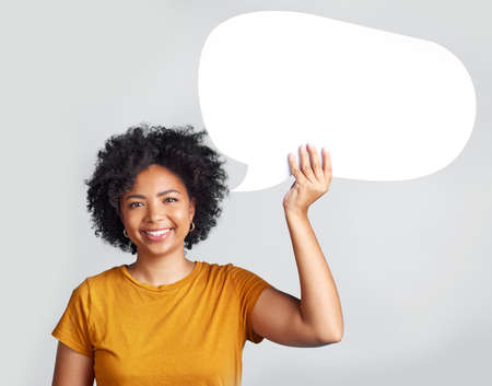 This should get the message across. a young woman holding up a speech bubble while posing against a...