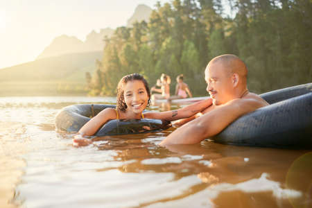 Another day, another dip. a young couple spending time together at a lake.の写真素材