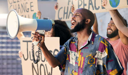 No change happens on its own. a group of young people protesting in the city.
