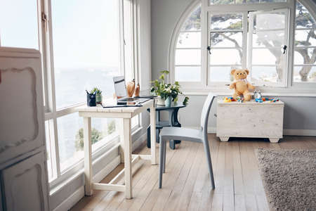 Perfect space for baby and me. an empty room with a working station and laptop.