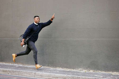 African american businessman travelling alone and rushing for a taxi in the city. Black male running...