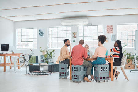 Group of happy diverse businesspeople having a meeting in a modern office at work. Colleagues...