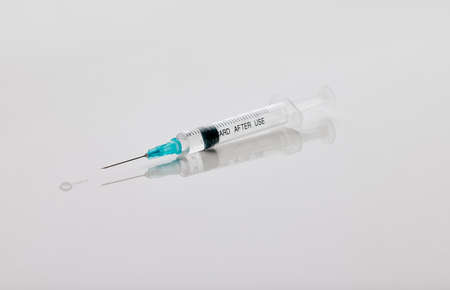 The cure is at the end of this needle. Closeup shot of a needle in an empty studio.