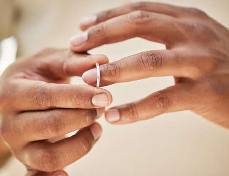 Man removing wedding band. Male hands taking off ring before going out to cheat. Finalising divorceの写真素材