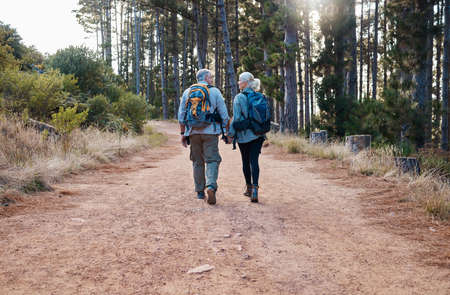 Theres no one else Id rather walk this path with. a mature couple holding hands while out hiking together.の写真素材