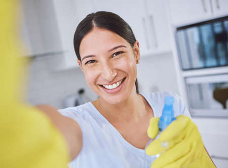 Its about to go down. a young woman cleaning her apartment.