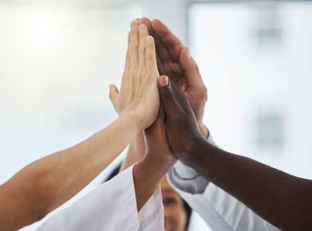 Uniting for the good of the patient. Closeup shot of a group of unrecognisable medical practitioners...