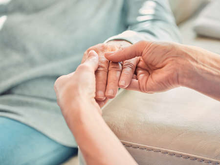 Every day the average person fights epic battles. a unrecognizable nurse massaging a womans hand at...