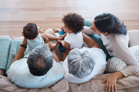 You can feel the love from any angle. a beautiful family bonding on a sofa at home.