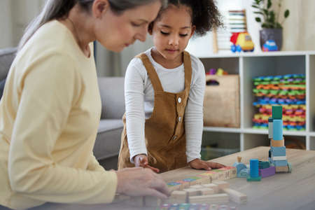 Being compassionate can make all the difference. a little girl playing with toys in a psychologists...