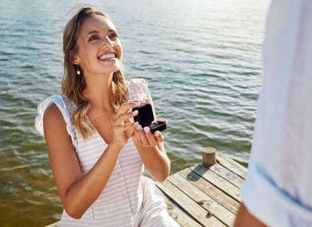 Taking matters into her own hands. a young woman proposing to her boyfriend in nature.