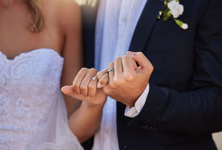 Were married and have the rings to prove it. an unrecognizable bride and groom on their wedding day.の写真素材