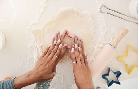Let me give you a hand. High angle shot of an unrecognizable woman and her daughter baking in the...