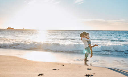 Its you and me forever. a young couple spending time together at the beach.の写真素材