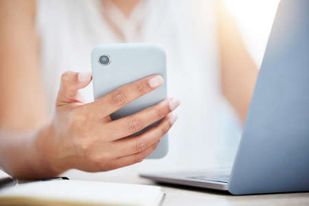 Just got another notification. Closeup shot of an unrecognisable businesswoman using a cellphone...