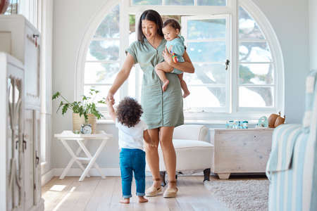 A mothers heart is full of love. a mother bonding with her two children at home.の写真素材