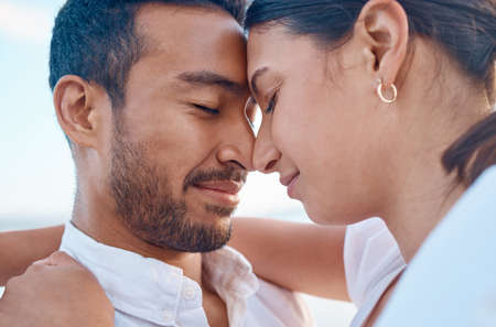 Everyone deserves to have a special person. a young couple spending time together at the beach.の写真素材