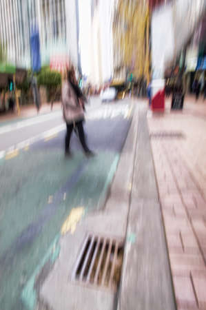 Strangers on their commute downtown in a city. Busy streets with a pedestrian crossing in blurry motion in Manhattan, New York. People walking around doing daily routine tasks.の写真素材