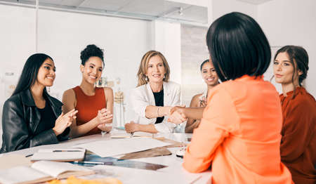 The start of great things. two businesswomen shaking hands in a meeting at work.の写真素材