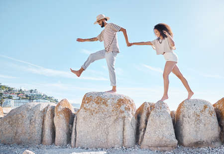 Take a chance on love. a young couple spending time together at the beach.の写真素材