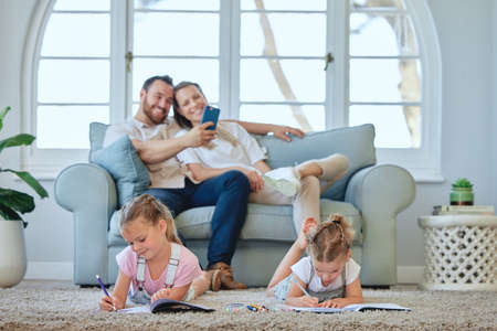 Drawing is their favourite activity. a young family relaxing at home.
