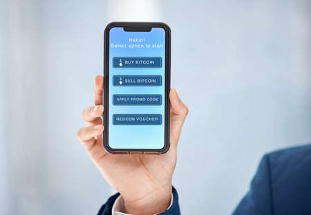 Choose an option. an unrecognizable businessperson using a phone at work.