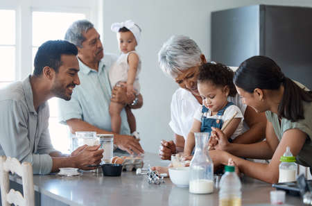 Meet the Bakers. a multigenerational family baking together in the kitchen.の写真素材