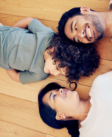 He came along and made us a family. a couple bonding with their son at home.