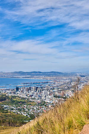 Landscape view of the city of Cape Town in South Africa. Beautiful scenic view of a popular tourist town with greenery and nature during summer. Ocean and residential in the Western Capeの写真素材